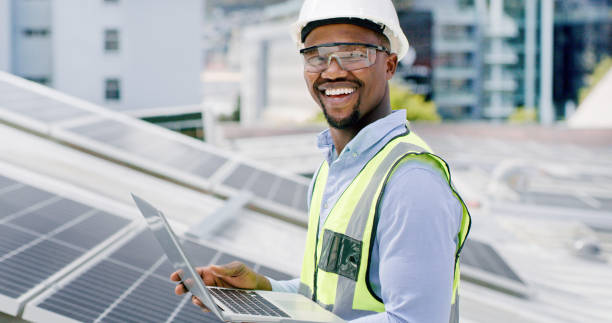 istock A young man using a laptop while installing solar panels on the roof of a building, A construction worker working online on a renewable energy project 1497846202