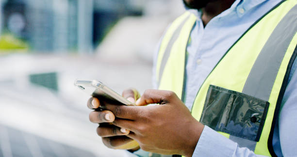 istock A man hands using a smartphone while installing solar panels on the roof of a building, Closeup of a construction worker working online with a phone on a renewable energy project 1497846742