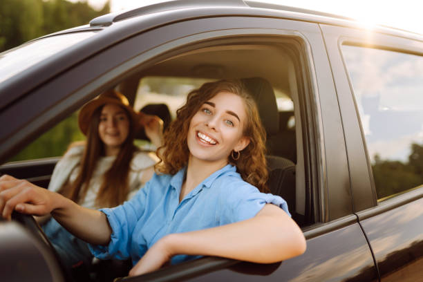 istock Two young women on car trip having fun. 1497848120