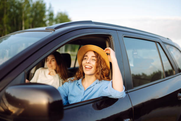 istock Two young women on car trip having fun. 1497848161