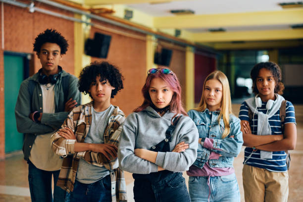 istock Multiracial group of confident high school students in a hallway looking at camera. 1497850134