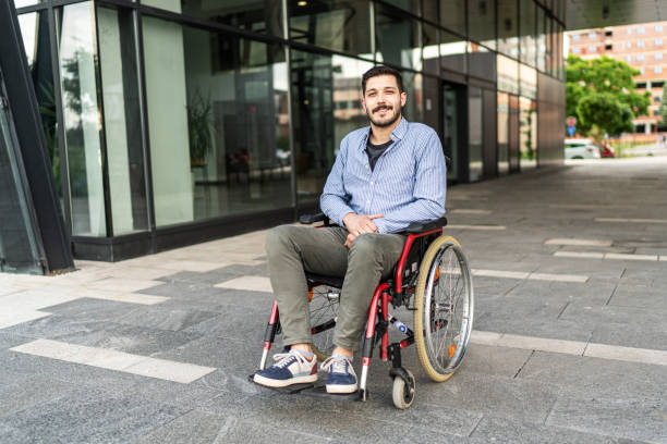 istock Handsome young disabled man on wheelchair outdoors 1497852014