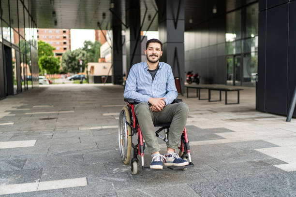 istock Handsome young disabled man on wheelchair outdoors 1497852182