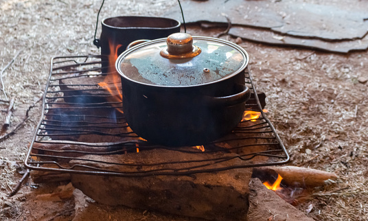 field kitchen, cooking on a camping trip, pot on fire