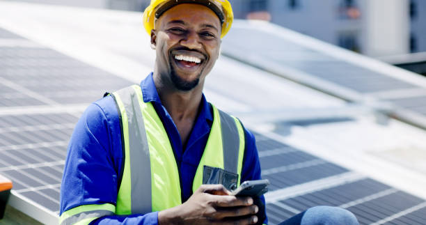istock A young man using a smartphone while installing solar panels on the roof of a building, A construction worker working online with his phone on a renewable energy project 1497853034