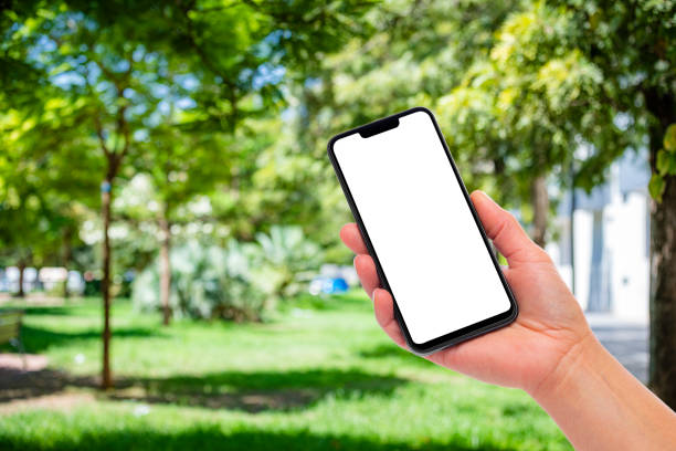 istock Hand holding mock-up smartphone outdoors 1497854967