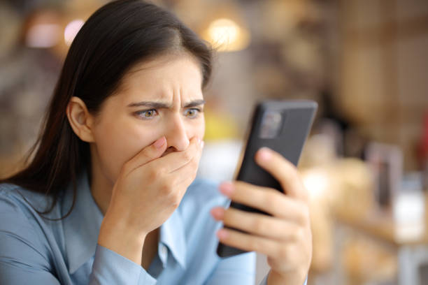 istock Terrified woman watching media content on phone 1497855159
