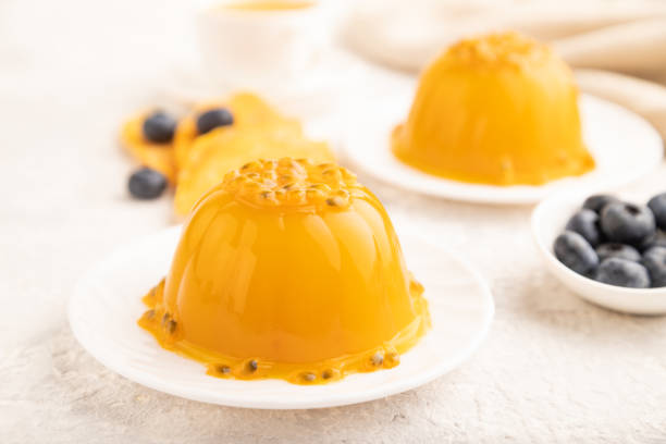 istock Mango and passion fruit jelly with blueberry on gray concrete, side view, selective focus. 1497857529