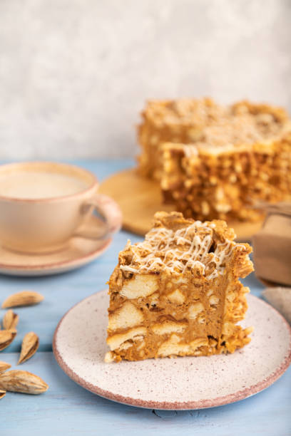 istock Traditional lithuanian cake shakotis with cup of coffee on blue, side view, selective focus. 1497857579