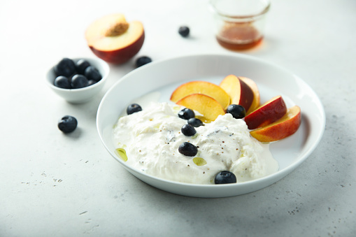 Fresh cheese with peach and blueberry