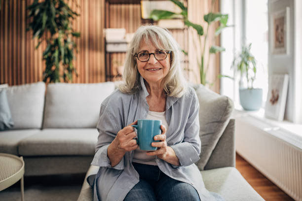 istock Senior woman drinking coffee and relaxing a home 1497862765