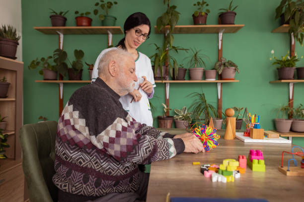 istock Colorful toy therapy session helps senior man 1497862818