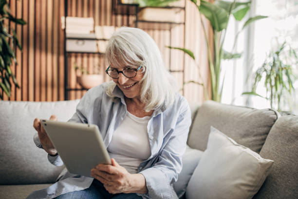 istock Senior woman using digital tablet at home 1497862837