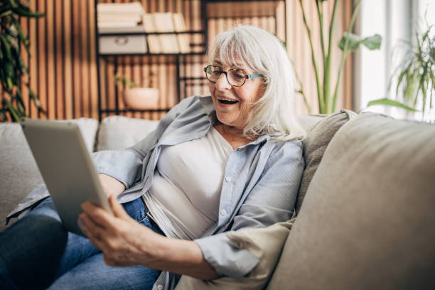 istock Senior woman using digital tablet at home 1497862876