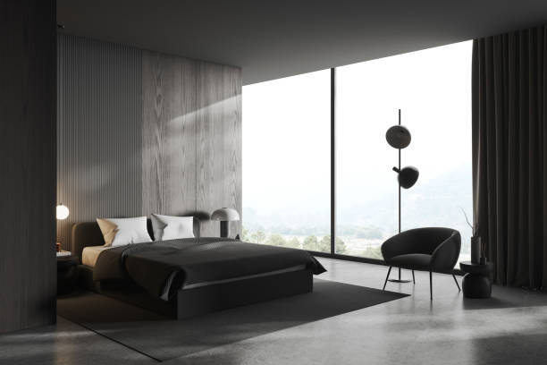 istock Dark bedroom interior with bed and armchair, panoramic window. Empty wall 1497862908