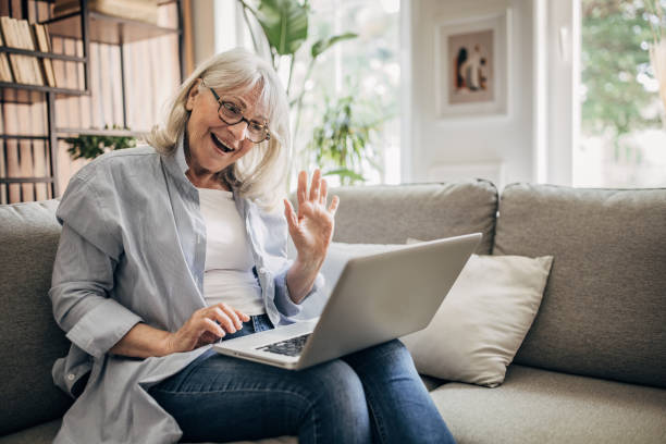 istock Senior woman using laptop at home 1497863045