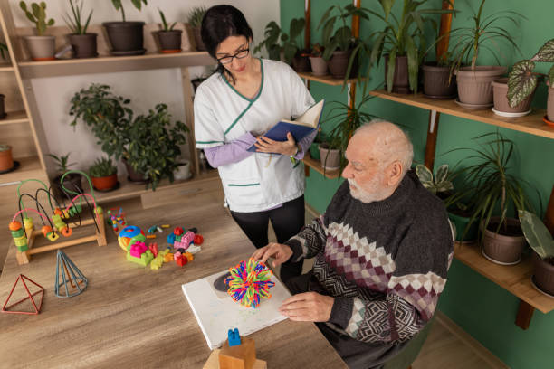 istock Senior man with dementia engages in therapeutic play session 1497863107