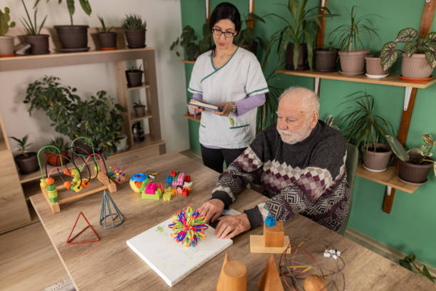 istock Senior man with dementia enjoys positive experience during therapy session 1497863169