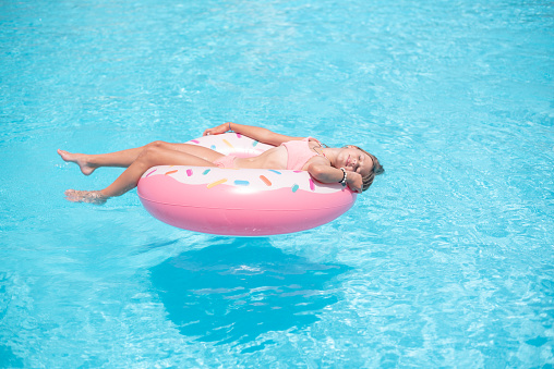 girl swimming in the pool on an inflatable circle