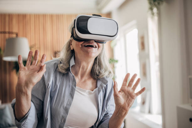 istock Senior woman having fun with vr glasses at home 1497864263