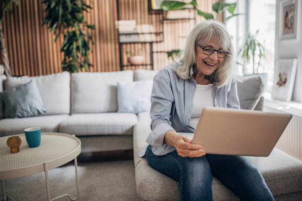 istock Senior woman using laptop at home 1497864806