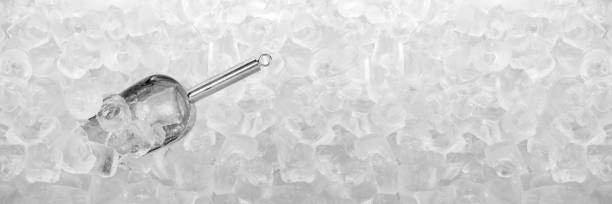 Ice scoop with ice cubes Close up stainless ice scoop with ice cubes in bucket top view use for food and beverage background ice machines stock pictures, royalty-free photos & images