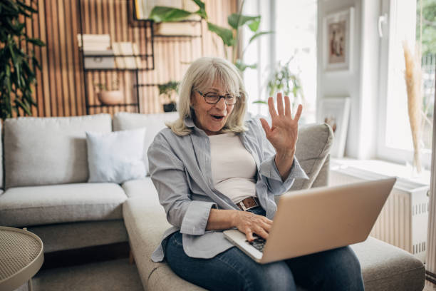 istock Senior woman using laptop at home 1497864989
