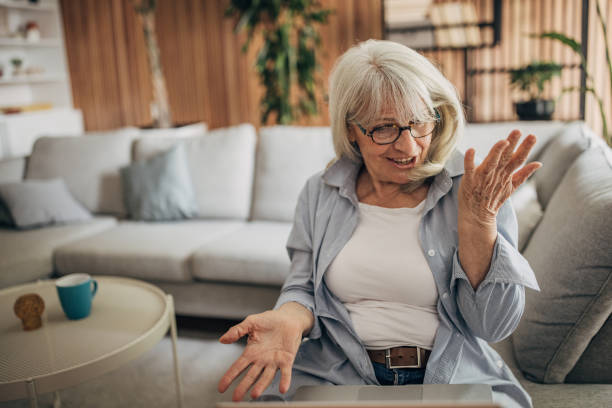 istock Senior woman using laptop at home 1497865105