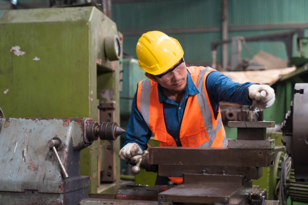 istock Man worker in safety helmet working on steel machine. Technicians and engineers are working and repairing machines in industrial plants. 1497865127