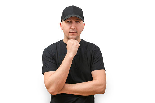 Portrait of a young man in a cap looking at the camera on a white background. Success concept