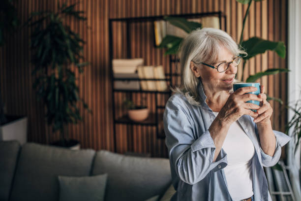 istock Senior woman drinking coffee and relaxing a home 1497866340