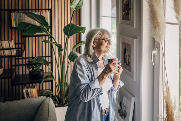 istock Senior woman drinking coffee and relaxing a home 1497866354