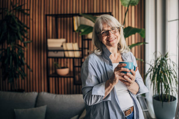 istock Senior woman drinking coffee and relaxing a home 1497866391