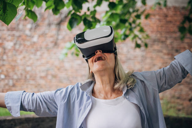 istock Senior woman having fun with vr glasses in the backyard 1497867942