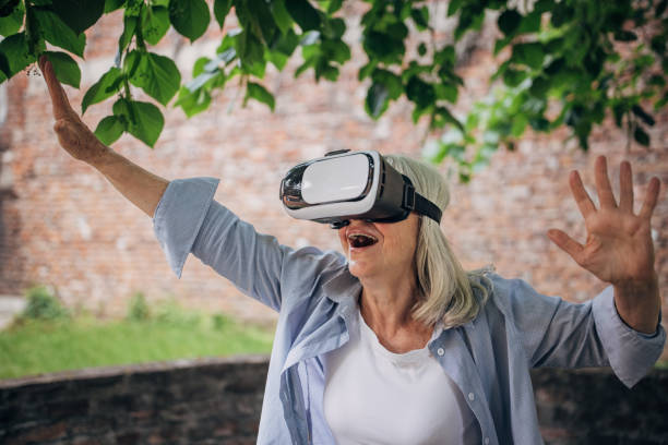 istock Senior woman having fun with vr glasses in the backyard 1497867953