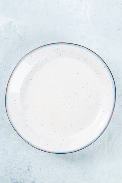 istock An empty white plate with a blue rim, top shot on a slate background 1497868273