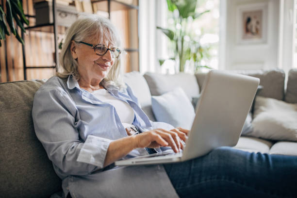 istock Senior woman using laptop at home 1497868625