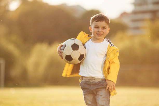 istock Boy is on the summer field with soccer ball 1497868629