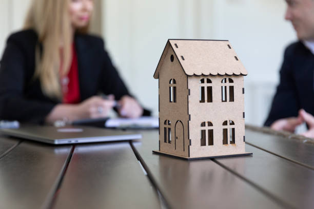 istock real estate agent and client discussing purchase in agency office 1497869925