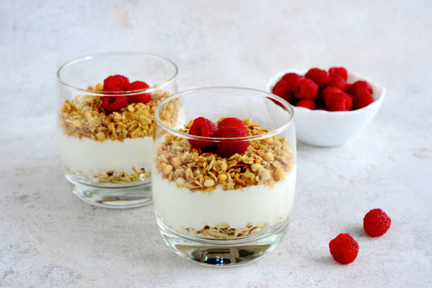 istock raspberry dessert with yoghurt and granola in drinking glass, close up 1497870157