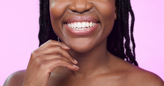 Happy woman, face or dental care on pink studio background or teeth whitening, invisible braces treatment or grooming. Zoom on beauty model smile or cosmetic mouth hygiene and healthcare cleaning