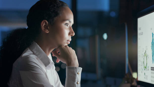 istock Business woman looking at information, analysing stats and a deadline while working in office alone at night. Corporate female professional, expert or programmer doing research in the dark 1497871965
