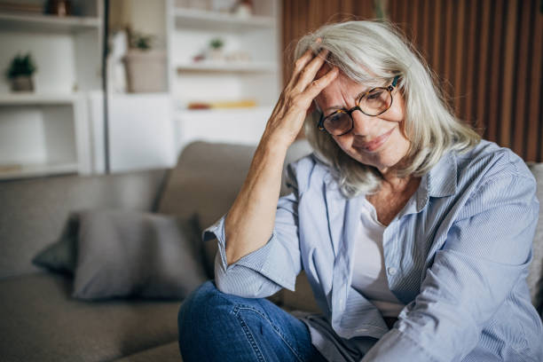 istock Depressed and sad senior woman at home 1497872221