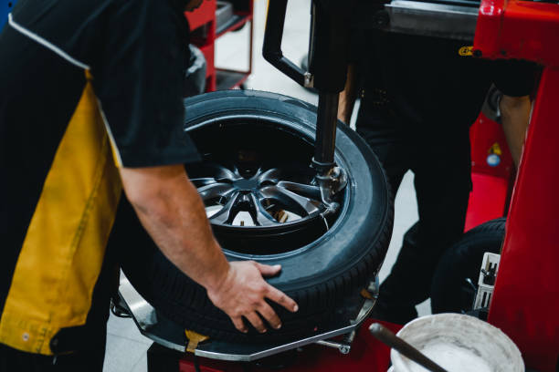 istock Mechanic changing tires on tire changer in auto service center. 1497872446