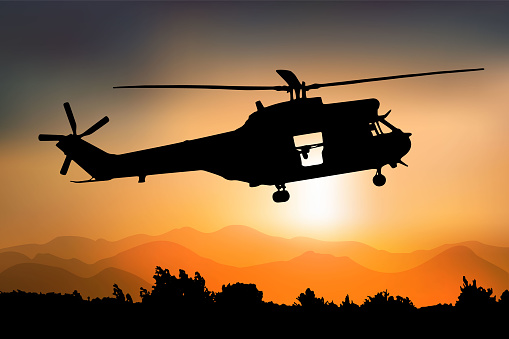 Silhouette of a combat helicopter at sunset, side view, puma in french army, vector drawing can be used for web, sticker, patch, logo, illustration and infographic