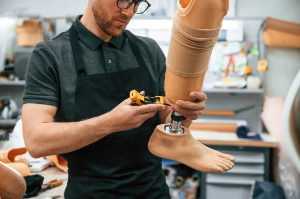 istock Tightening the screws. Technician working with prosthesis in modern laboratory 1497875169