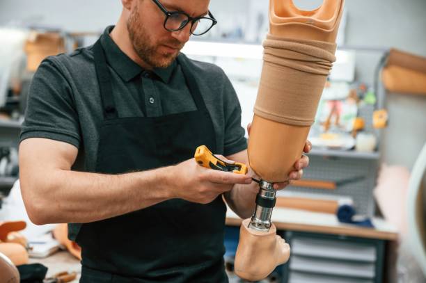 istock Tightening the screws. Technician working with prosthesis in modern laboratory 1497875189