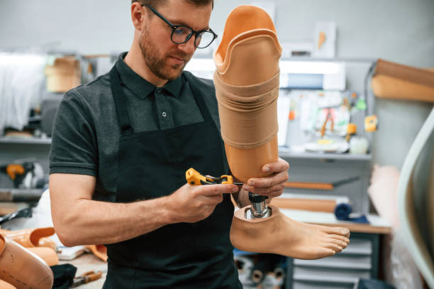 istock Tightening the screws. Technician working with prosthesis in modern laboratory 1497875191