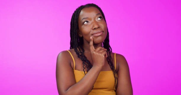 istock Thinking, idea and thoughtful black woman in studio planning, daydreaming or contemplating. Young, smart and beautiful African female model with pensive face expression isolated by purple background. 1497875579