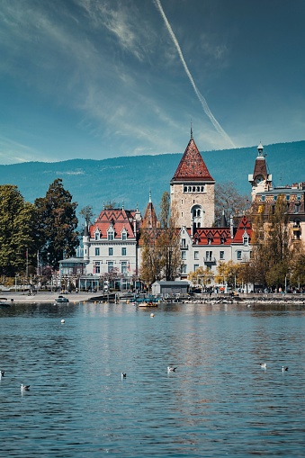 A picturesque view of Chateau Ouchy on the waterfront of Lake Geneva in Lausanne, Switzerland